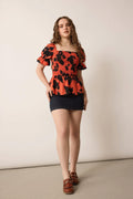 Bailey in Bold Peplum Top In Orange and Black